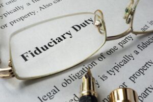 A closeup of the definition of fiduciary duty written on a piece of paper.