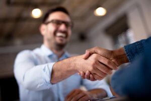 A man shakes his hand with a financial advisor.